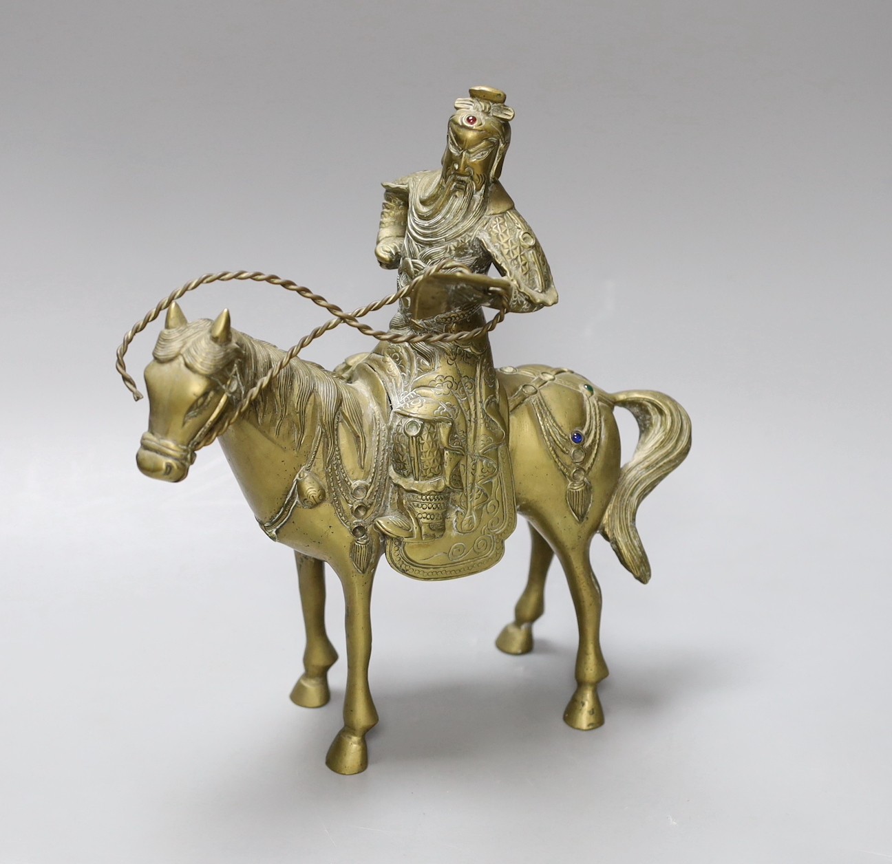 An early 20th century Chinese bronze group of Guandi riding a horse, 24 cms high